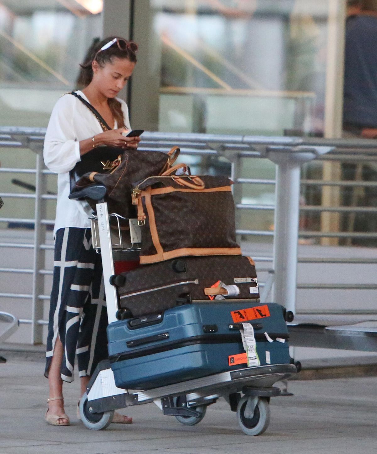 Alicia Vikander carries a large Louis Vuitton bag as she arrives