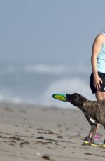 LINDSEY VONN in Shorts Walks Her Dog Leo on the Beach