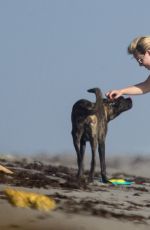 LINDSEY VONN in Shorts Walks Her Dog Leo on the Beach