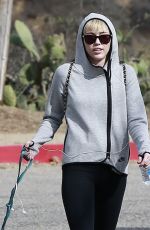 MILEY CYRUS Walking Her Dog Out in Beverly Hills