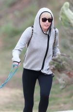 MILEY CYRUS Walking Her Dog Out in Beverly Hills