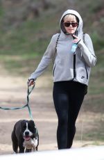 MILEY CYRUS Walking Her Dog Out in Beverly Hills