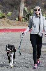 MILEY CYRUS Walking Her Dog Out in Beverly Hills