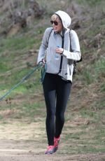 MILEY CYRUS Walking Her Dog Out in Beverly Hills