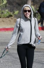 MILEY CYRUS Walking Her Dog Out in Beverly Hills