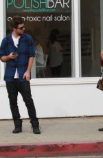 ASHLEY BENSON in Knee High Boots Out Shopping in Hollywood