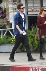 ASHLEY BENSON in Knee High Boots Out Shopping in Hollywood