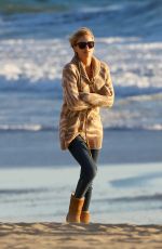 CHARLIZE THERON Walking on the Beach at Sunset