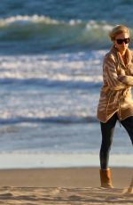 CHARLIZE THERON Walking on the Beach at Sunset