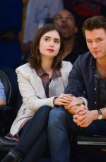 LILY COLLINS and Thomas Cocquerel at Lakers vs Bulls Game in Los Angeles