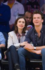 LILY COLLINS and Thomas Cocquerel at Lakers vs Bulls Game in Los Angeles