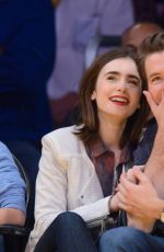 LILY COLLINS and Thomas Cocquerel at Lakers vs Bulls Game in Los Angeles