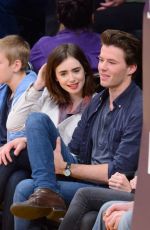 LILY COLLINS and Thomas Cocquerel at Lakers vs Bulls Game in Los Angeles