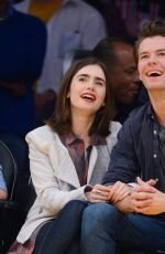 LILY COLLINS and Thomas Cocquerel at Lakers vs Bulls Game in Los Angeles