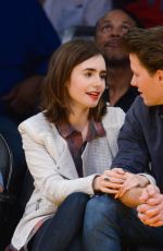 LILY COLLINS and Thomas Cocquerel at Lakers vs Bulls Game in Los Angeles