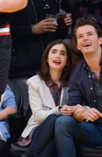 LILY COLLINS and Thomas Cocquerel at Lakers vs Bulls Game in Los Angeles