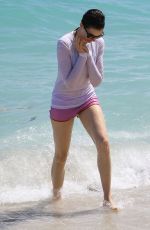 ANNE HATHAWAY in a Covered Bikini on the Beach in Miami