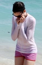 ANNE HATHAWAY in a Covered Bikini on the Beach in Miami