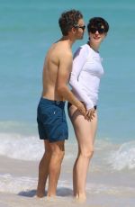 ANNE HATHAWAY in a Covered Bikini on the Beach in Miami