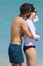 ANNE HATHAWAY in a Covered Bikini on the Beach in Miami