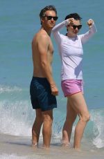 ANNE HATHAWAY in a Covered Bikini on the Beach in Miami