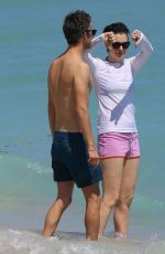 ANNE HATHAWAY in a Covered Bikini on the Beach in Miami