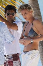 CHARLIZE THERON in Bikini at a Photoshoot on the Beach in Miami