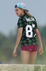MICHELLE RODRIGUEZ and CARA DELEVINGNE Cuddle on a Beach