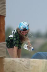MICHELLE RODRIGUEZ and CARA DELEVINGNE Cuddle on a Beach