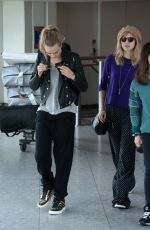 CARA DELEVINGNE and SUKI WATERHOUSE at Heathrow Airport in London