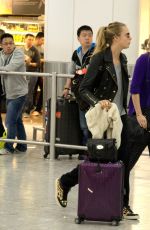 CARA DELEVINGNE and SUKI WATERHOUSE at Heathrow Airport in London
