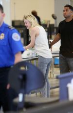 DAKOTA FANNING in Jeans at LAX Airport