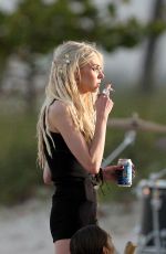 TAYLOR MOMSEN on the Set for a Music Video at a Beach in Miami