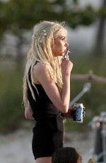 TAYLOR MOMSEN on the Set for a Music Video at a Beach in Miami