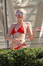 MILEY CYRUS in Bikini at a Hotel Pool in Barcelona