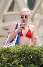 MILEY CYRUS in Bikini at a Hotel Pool in Barcelona