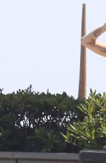 MILEY CYRUS in Bikini Top at a Pool in Barcelona