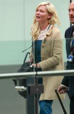 KIRSTEN DUNST at Heathrow Airport in London