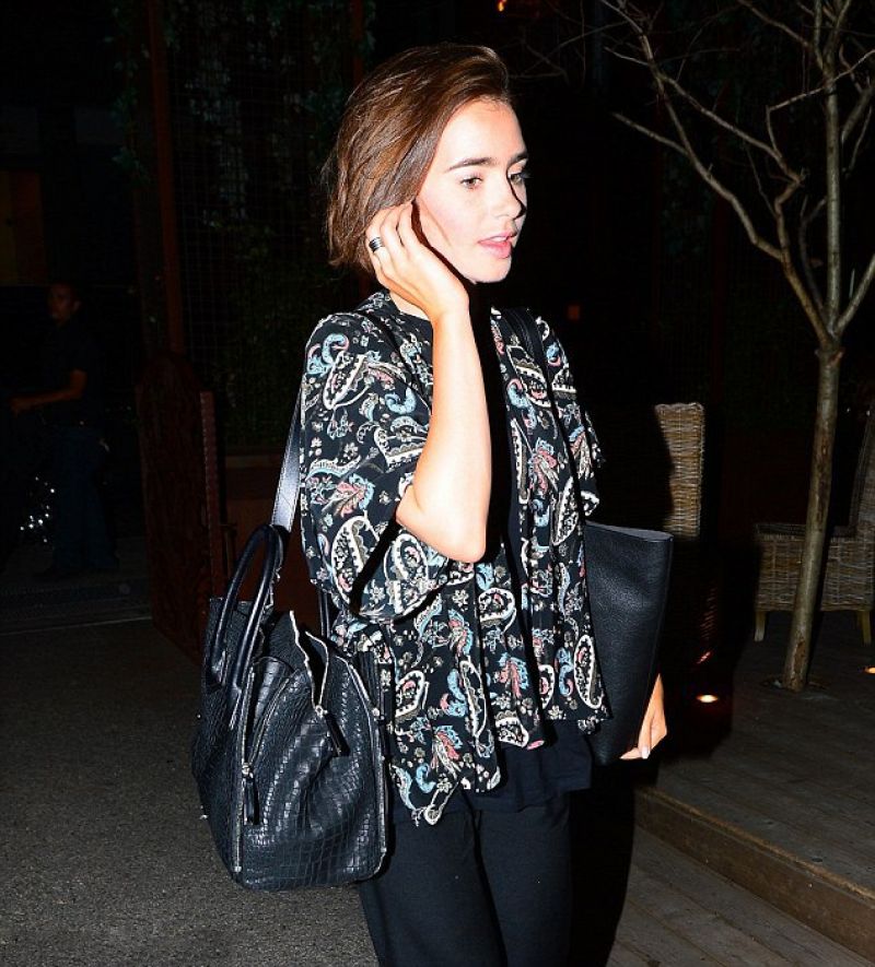 LILY COLLINS Leaves Her Hotel in New York LILY COLLINS Leaves Her Hotel in New York