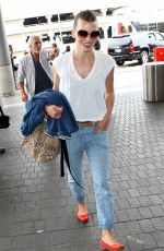MILLA JOVOVICH Arrives at LAX Airport