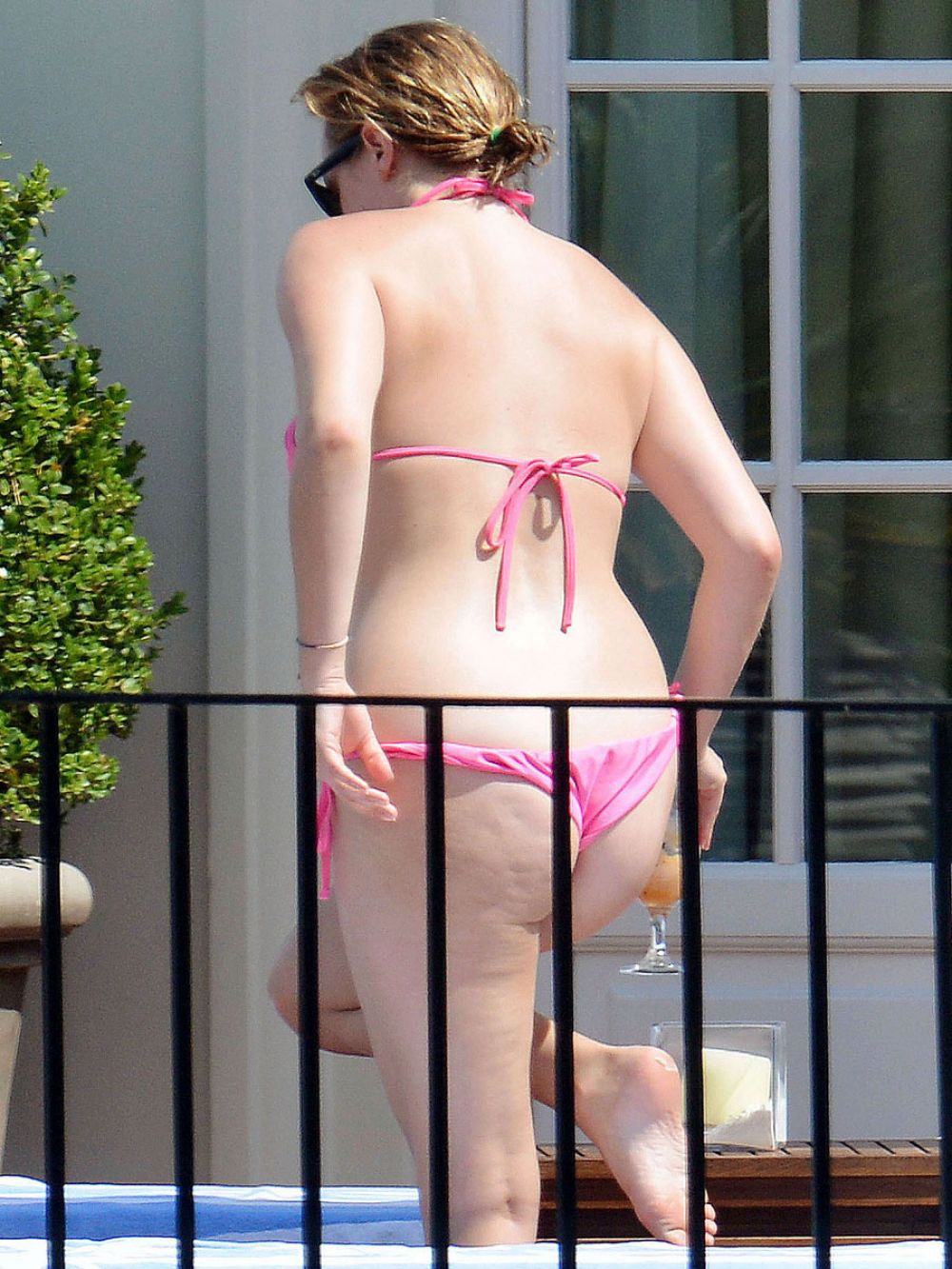 ELISABETH MOSS in Bikini at a Hotel Balcony in Capri.