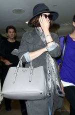 LILY COLLINS ar Los Angeles International Airport 2309