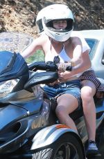 MILEY CYRUS Riding a Motorcycle Out in Beverly Hills
