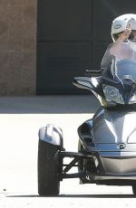 MILEY CYRUS Riding a Motorcycle Out in Beverly Hills