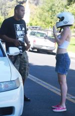 MILEY CYRUS Riding a Motorcycle Out in Beverly Hills