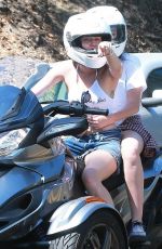 MILEY CYRUS Riding a Motorcycle Out in Beverly Hills