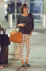 MILLA JOVOVICH Arrives at JFK Arport in New York