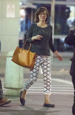 MILLA JOVOVICH Arrives at JFK Arport in New York