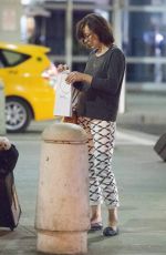 MILLA JOVOVICH Arrives at JFK Arport in New York