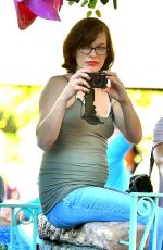 Pregnant MILLA JOVOVICH at Disneyland in Anaheim